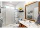 Full bathroom with hardwood floors, walk in shower with glass door, lots of light, and a single vanity at 3024 Calusa Dr., Little River, SC 29566