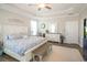 Bright primary bedroom with trey ceilings, hardwood floors, lots of natural light, and a bench seat at 3024 Calusa Dr., Little River, SC 29566