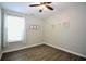 Bright bedroom featuring wood floors, a window with natural light, and decorative wall hangings at 3024 Calusa Dr., Little River, SC 29566