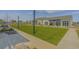 Expansive clubhouse exterior with large lawn and string lighting at 3024 Calusa Dr., Little River, SC 29566