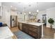 Open concept kitchen with a spacious island, granite countertops, stainless steel appliances, and modern lighting at 3024 Calusa Dr., Little River, SC 29566