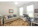 Home office with plush beige sofa, hardwood floors, lots of natural light, and desk at 3024 Calusa Dr., Little River, SC 29566
