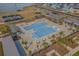 Aerial view of a large community pool featuring ample seating, lounge chairs and lake views at 3024 Calusa Dr., Little River, SC 29566