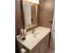A classic bathroom features wallpaper, a framed mirror, a vanity with a white countertop, and decorative towels at 310 N 73Rd Ave. N # 5D, Myrtle Beach, SC 29572