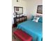 A well-decorated bedroom features a comfortable bed with turquoise linens, a dresser, and stylish furnishings at 310 N 73Rd Ave. N # 5D, Myrtle Beach, SC 29572