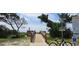 Wooden boardwalk leading to the beach, framed by lush greenery and clear blue skies at 310 N 73Rd Ave. N # 5D, Myrtle Beach, SC 29572