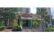 Charming River City Cafe exterior featuring colorful accents, a welcoming entrance, and lush tropical landscaping at 310 N 73Rd Ave. N # 5D, Myrtle Beach, SC 29572