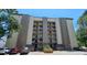 Multi-story condominium building featuring individual balconies with gray and tan facade on a sunny day at 310 N 73Rd Ave. N # 5D, Myrtle Beach, SC 29572