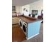 Bright kitchen with stainless steel appliances, cabinets, breakfast bar, three barstools and washer and dryer at 310 N 73Rd Ave. N # 5D, Myrtle Beach, SC 29572