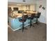 Kitchen featuring stainless steel appliances, breakfast bar, and three stools perfect for gatherings at 310 N 73Rd Ave. N # 5D, Myrtle Beach, SC 29572