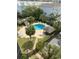 Aerial view of a community pool with blue water, surrounded by lush greenery and palm trees, perfect for relaxation at 310 N 73Rd Ave. N # 5D, Myrtle Beach, SC 29572