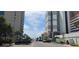 Street view shows condo buildings, parked cars, and a distant ocean view on a sunny day at 310 N 73Rd Ave. N # 5D, Myrtle Beach, SC 29572