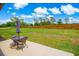 Spacious backyard with a green lawn, privacy fence, and patio furniture for outdoor living at 3117 Chapel Rd., Loris, SC 29569