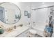 Updated bathroom features a granite vanity, round mirror, toilet and shower/tub combination at 3117 Chapel Rd., Loris, SC 29569