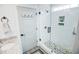 Tiled walk-in shower with a river rock floor and dual built-in storage in a beautifully renovated bathroom at 3117 Chapel Rd., Loris, SC 29569