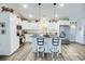 Bright kitchen featuring white cabinets, stainless steel appliances, granite countertops, and a convenient island with barstools at 3117 Chapel Rd., Loris, SC 29569