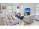 This living room offers ample natural light, complemented by cozy seating and a neutral palette for relaxation and entertainment at 3117 Chapel Rd., Loris, SC 29569