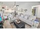 Open-concept living room features a ceiling fan, stylish furniture, and a kitchen view, creating a bright and inviting space at 3117 Chapel Rd., Loris, SC 29569