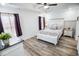 Cozy main bedroom with decorative ceiling, tray ceiling, stylish furnishings, and ample natural light from windows with privacy curtains at 3117 Chapel Rd., Loris, SC 29569