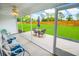 Relaxing screened-in patio with comfortable seating overlooking a large backyard with green grass at 3117 Chapel Rd., Loris, SC 29569