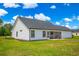 Back of house with a screened porch offers a comfortable outdoor space to enjoy the beautiful surroundings at 3117 Chapel Rd., Loris, SC 29569