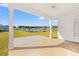 Covered back porch with ceiling fan and a view to a pond and neighboring homes at 3324 Little Bay Dr., Conway, SC 29526