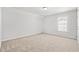 Well-lit bedroom with neutral carpet, a single window, and a closet door at 3324 Little Bay Dr., Conway, SC 29526