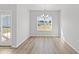 Bright dining room with wood floors, chandelier, and large window with natural light at 3324 Little Bay Dr., Conway, SC 29526