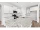 Modern kitchen features granite countertops, stainless steel appliances, and white cabinetry at 3324 Little Bay Dr., Conway, SC 29526