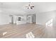 Open-concept living room with wood floors leading to kitchen with island and stainless appliances at 3324 Little Bay Dr., Conway, SC 29526