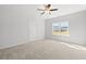 Bright main bedroom featuring plush carpet, a window with a view to the neighborhood and a door at 3324 Little Bay Dr., Conway, SC 29526