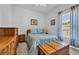 Cozy bedroom with a comfortable bed, wooden furniture, and natural light from the window at 366 Fennec Loop, Conway, SC 29526