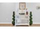 Coastal-style entryway featuring a white console table adorned with nautical decor and potted topiaries at 366 Fennec Loop, Conway, SC 29526