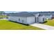 Beautiful one-story home displaying gray siding, a dark roof, and a well-maintained lawn leading to the garage at 366 Fennec Loop, Conway, SC 29526