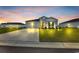 Charming one-story home with gray siding, a dark roof, a well-manicured lawn, and an attached garage at dusk at 366 Fennec Loop, Conway, SC 29526