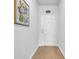 Bright hallway with wood-look floors, neutral walls, and a charming floral print adding a touch of elegance at 366 Fennec Loop, Conway, SC 29526
