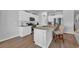 Well-lit kitchen with an island, stainless steel appliances and bright white cabinetry at 366 Fennec Loop, Conway, SC 29526