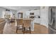 Modern open-concept kitchen with white cabinets, stainless steel appliances and eat-in island at 366 Fennec Loop, Conway, SC 29526