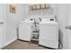 Bright laundry room featuring a washer, dryer, overhead storage, and tile flooring at 366 Fennec Loop, Conway, SC 29526