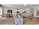 Open-concept living area boasts a modern sectional, and an adjacent dining area at 366 Fennec Loop, Conway, SC 29526