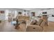 Bright, open living space with large sectional sofa and a connecting view of the kitchen at 366 Fennec Loop, Conway, SC 29526