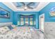 This bedroom has a tray ceiling, ceiling fan, and large bay window with a window seat at 3907 Club Course Dr., North Myrtle Beach, SC 29582