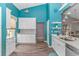 Bright kitchen featuring modern white cabinets, marble countertops, stainless steel appliances and blue accent walls at 3907 Club Course Dr., North Myrtle Beach, SC 29582