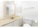 Bright bathroom with a toilet, vanity, and a mirror at 404 75Th Ave N # G, Myrtle Beach, SC 29572