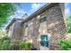 View of the brick exterior of this home, with trees on the left and bright blue sky above at 404 75Th Ave N # G, Myrtle Beach, SC 29572