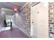 View of the building's hallway, with exit sign overhead and door with unit number on the right at 404 75Th Ave N # G, Myrtle Beach, SC 29572