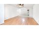 Spacious living room with hardwood floors, a ceiling fan, and views into the dining area and kitchen at 404 75Th Ave N # G, Myrtle Beach, SC 29572
