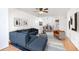 Living room furnished with blue sofa, neutral armchair, and view into the dining area and kitchen at 404 75Th Ave N # G, Myrtle Beach, SC 29572
