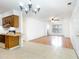 Living room featuring tile flooring, wood cabinets, and a ceiling fan opening into another room at 404 75Th Ave N # G, Myrtle Beach, SC 29572