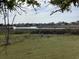 Scenic marsh view with waterfront homes in the distance, framed by tree branches overhead at 409 Salt Marsh Circle # 20C, Pawleys Island, SC 29585